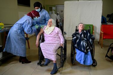  An elderly woman receives a dose of the Pfizer-BioNTech vaccine against Covid-19 at the Dar Al-Ajaza Al-Islamia Hospital (House of Muslim elderly) in Beirut. Around 28,000 doses of the Pfizer-BioNTech vaccine arrived in Lebanon on February 13 . The first doses will go to the elderly and health workers according to the high risk groups priority order. EPA
