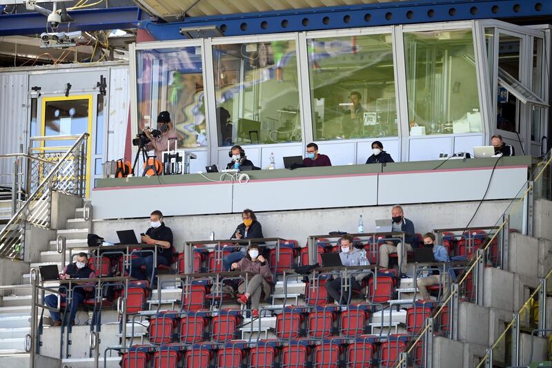 Journalists work in the media stand during the Second Bundesliga match between Karlsruher SC and SV Darmstadt 98 at Wildparkstadion in Karlsruhe, Germany. Getty