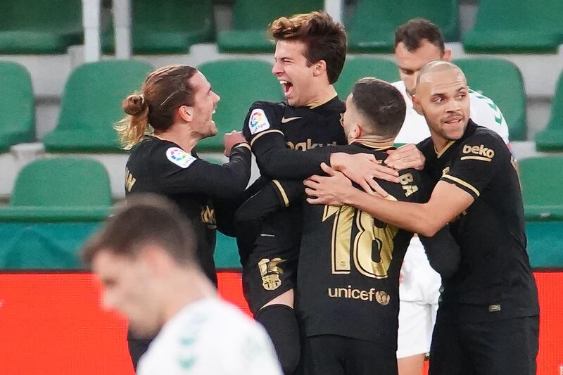 Barcelona's midfielder Riqui Puig, centre, celebrates his goal against Elche at the Martinez Valero Stadium on Sunday. AFP