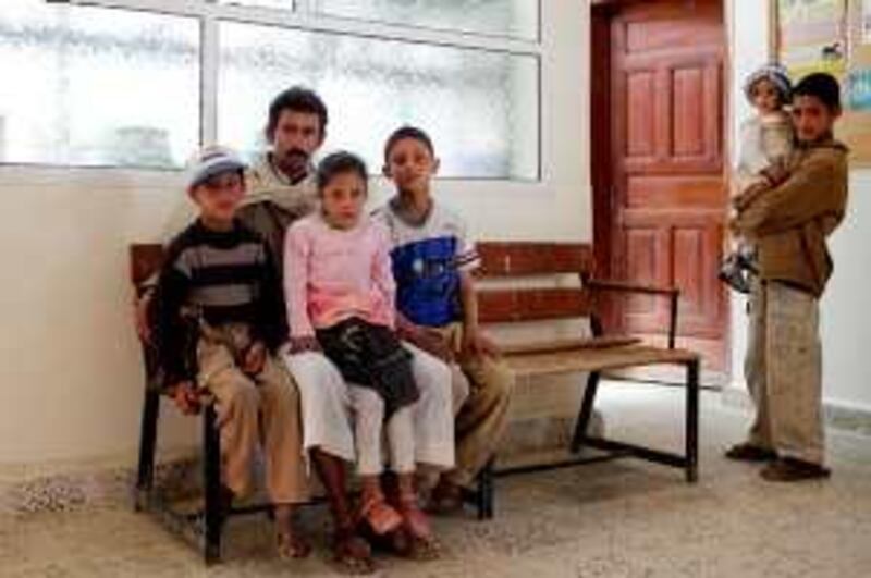 THULA, AMRAN, YEMEN - February 3, 2010: 
(2nd from left) Yaya Salama, sits for portrait with his children (left) Mohamed, 8, (pink, centre) Gihan, 6 and (blue, right) Ismail, 11. (far right) Niece and nephew of Yaya; Bashir, 10, holds his sister Anut, 2, who is acutely malnourished.
Yemen is the 3rd most malnourished country in the world, where 58 percent of the children suffer from malnourishment and 45 percent of the population lives below the poverty line. ( Ryan Carter / The National )

*** for story by Nugh Naylor ***