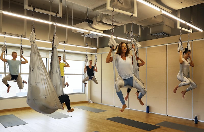 ABU DHABI , UNITED ARAB EMIRATES , SEP 21  ��� 2017 : - Pem Fassa , Yoga instructor ( 2nd right ) during the Anti Gravity Yoga class at the YogaOne Studio in Abu Dhabi. ( Pawan Singh / The National ) Story by Anna Marie McQueen