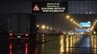 A road screen board alerts motorists of water ponds caused by heavy rainfall in Dubai, UAE. EPA