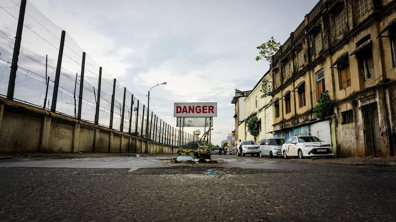 A danger sign lies in the road before the scene of a controlled explosion in Colombo, Sri Lanka, April 22, 2019. Jack Moore / The National. 

