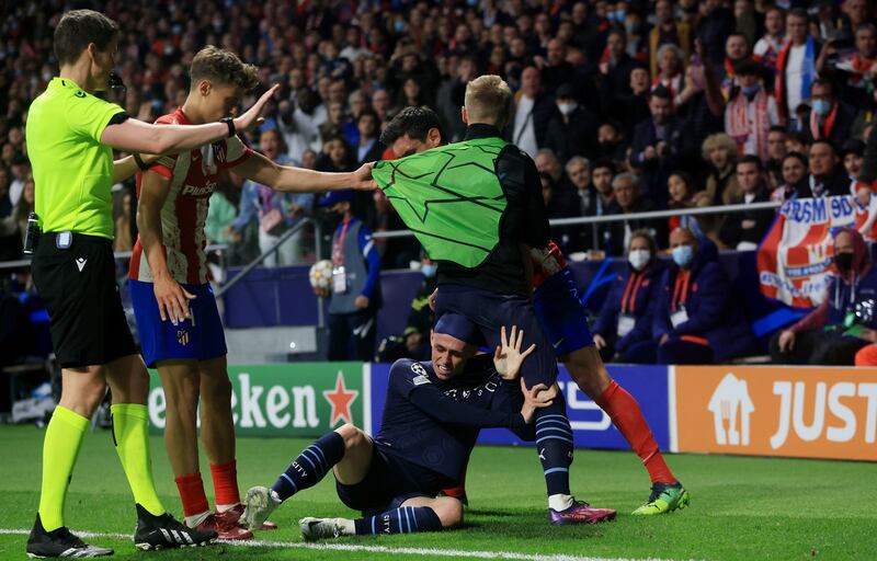 Phil Foden and Oleksandr Zinchenko clash with Atletico Madrid's Marcos Llorente and  Stefan Savic. Action Images