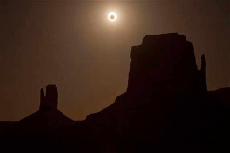 The new moon crosses in front of the sun creating an annular eclipse over West Mitten, left, and East Mitten buttes, Sunday, May 20, 2012, in Monument Valley, Ariz. (AP Photo/Julie Jacobson)