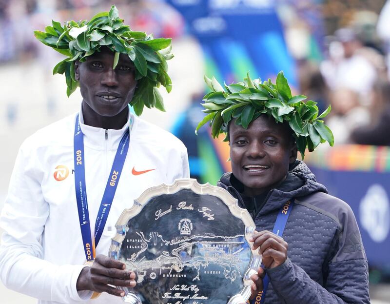 First place finishers Joyciline Jepkosgei of Kenya and Geoffrey Kamworor of Kenya pose during the 2019 TCS New York City Marathon in New York on November 3, 2019. - Geoffrey Kamworor and Joyciline Jepkosgei sealed a double victory for Kenya at the New York Marathon on Sunday, storming to convincing wins in the men's and women's races at the annual showpiece. Kamworor, the 2017 New York champion, pulled clear in the closing stages to take the tape in Central Park 2hr 8min 13sec. (Photo by TIMOTHY A. CLARY / AFP)
