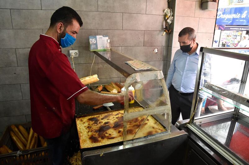 A man buys a sandwich at a shop in the Algerian capital Algiers.   AFP