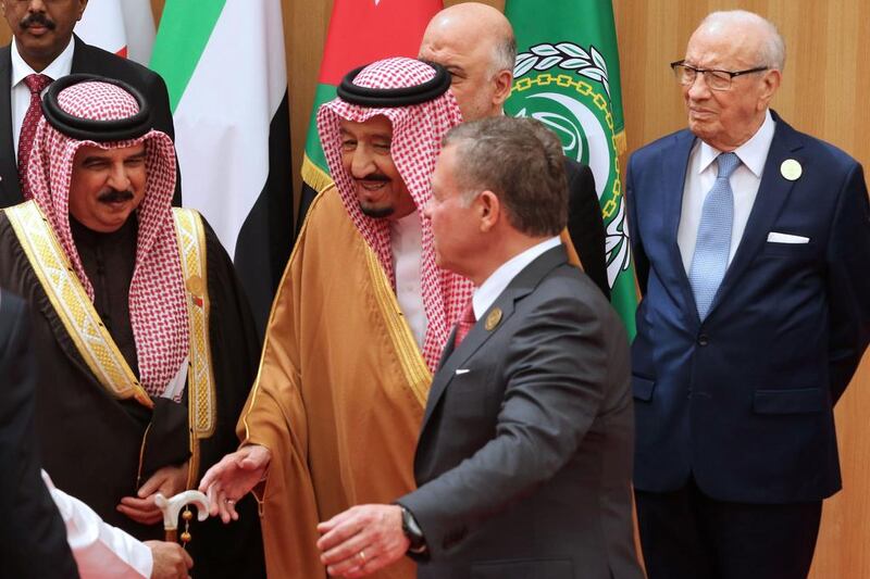 Jordan’s King Abdullah II, second from right, talking to Saudi Arabia’s King Salman, with Tunisian president Beji Caid Essebsi, right, standing behind them. Khalil Mazraawi / AFP