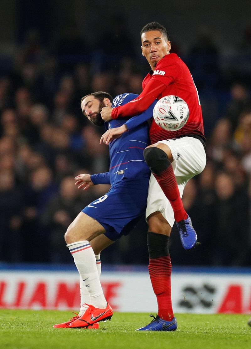 Manchester United's Chris Smalling in action with Chelsea's Gonzalo Higuain. Reuters