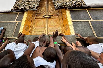 Worshippers touch the Kaaba at the Grand Mosque in Makkah. AFP
