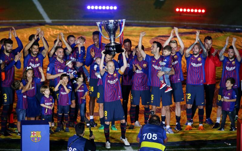 Barcelona's Andres Iniesta and team mates celebrate with the La Liga trophy after the match . Albert Gea / Reuters
