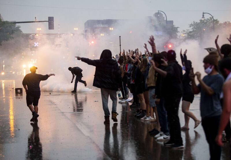 Tear gas is fired as protesters clash with police while demonstrating against the death of George Floyd outside the 3rd Precinct Police Precinct in Minneapolis, Minnesota. AFP