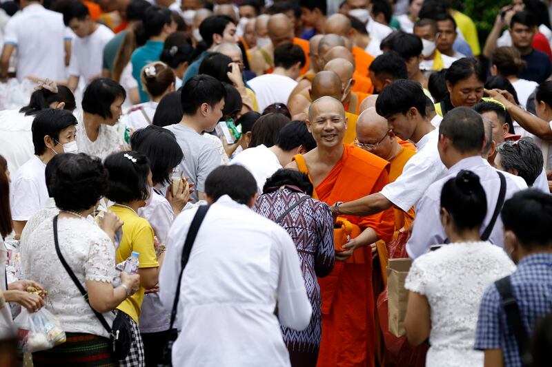 Thai Buddhist monks receive donations from devotees, marking the end of the Buddhist lent, in Bangkok. EPA