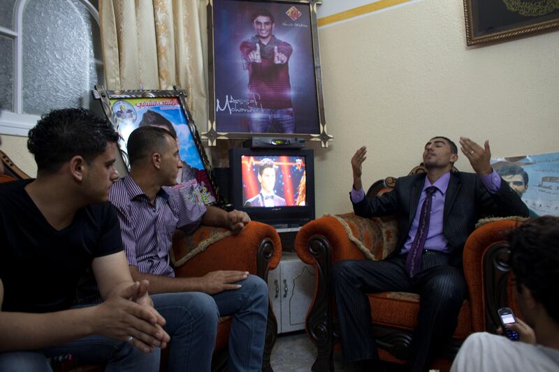 Shadi Assaf prays for his brother  Mohammed Assaf to win as he and other family members and friends gathere at the family's  home  in Khan Younis, Gaza June 22,2013.Millions watching the regional 'Arab Idol' singing contest on television .Mohammed Assaf ,23,  from a refugee camp in Khan Younis in the Gaza Strip brought celebrations to the Gaza Strip and West Bank as he was named the winner of the contest Saturday night in Beirut ,Lebanon June 22,2013. Thousands of Palestinians in Gaza and the West Bank took to the streets to celebrate his victory . (Photo by Heidi Levine/Sipa Press). *** Local Caption ***  IMG_0427.jpg