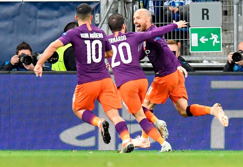 Manchester City's David Silva, right, celebrates scoring the 1-2 goal with his teammates. AFP