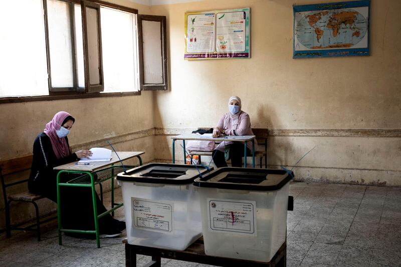 Election officials wait for people to vote on the first day of the Senate elections. AP Photo