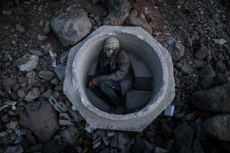 An Afghan boy hides inside a sewer pipe near Van after crossing the Iran-Turkey border. Illegal immigrants often wait for days for smugglers to take them towards western Turkey. EPA