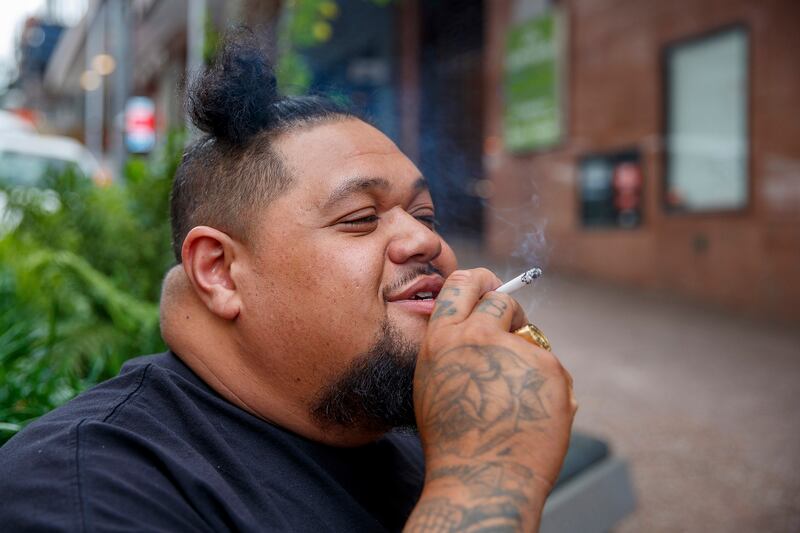 A smoker in Auckland on Thursday, where New Zealand's government believes it has come up with a unique plan to end tobacco smoking. AP