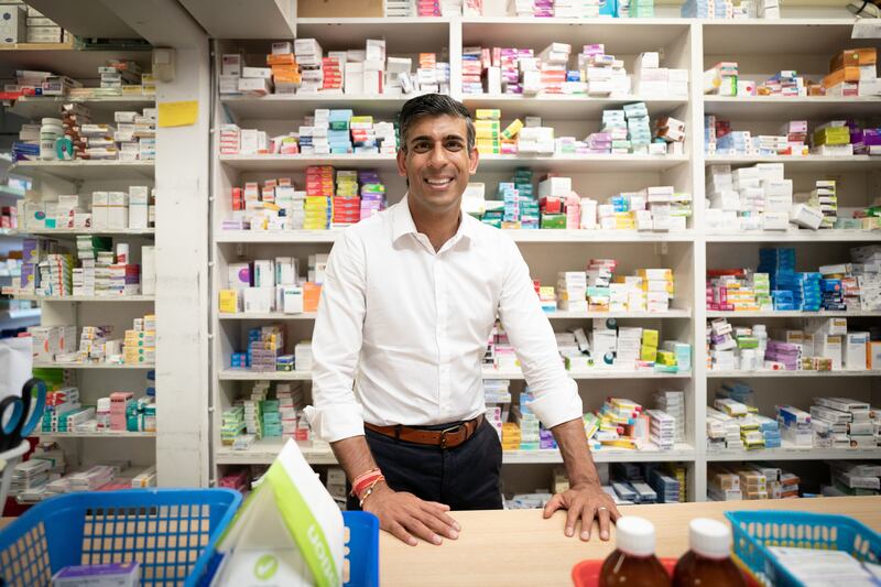 Mr Sunak visits his family's old business, Bassett Pharmacy, on the campaign trail in August 2022. Getty Images