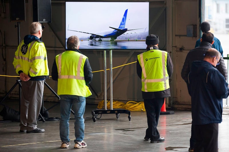 Boeing employees and guests watch coverage as they welcome a Boeing 777X airplane returning from its inaugural flight at Boeing Field in Seattle.  AFP