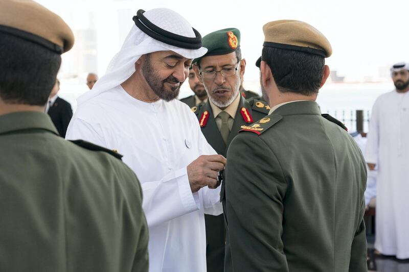 ABU DHABI, UNITED ARAB EMIRATES - March 5, 2018: HH Sheikh Mohamed bin Zayed Al Nahyan, Crown Prince of Abu Dhabi and Deputy Supreme Commander of the UAE Armed Forces (center L), presents a bravery medal to a member of the UAE Armed Forces, during a Sea Palace barza. Seen with HE Lt General Hamad Thani Al Romaithi, Chief of Staff UAE Armed Forces (back center R). 
( Ryan Carter for the Crown Prince Court - Abu Dhabi )