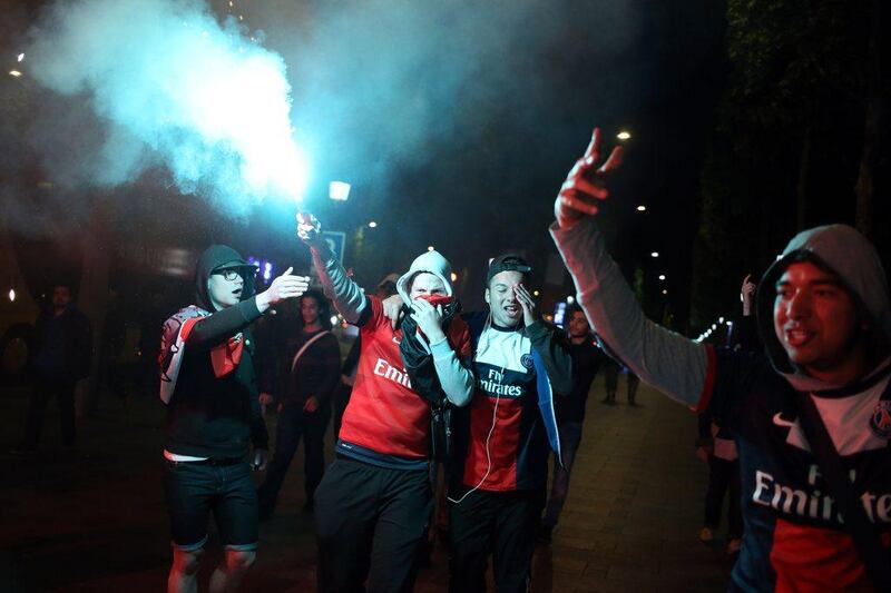 PSG supporters celebrate in Paris on Wednesday after the club were crowned Ligue 1 champions. Kenzo Tribouillard / AFP / May 7, 2014