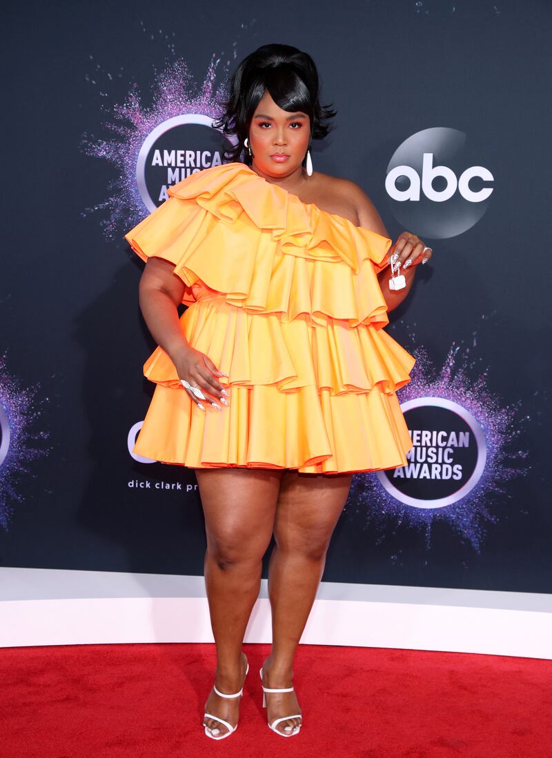 Lizzo in a ruffled Valentino dress with her tiny purse at the 2019 American Music Awards. Getty Images