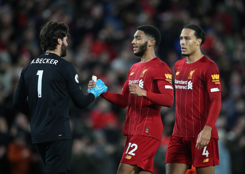 Soccer Football - Premier League - Liverpool v Sheffield United - Anfield, Liverpool, Britain - January 2, 2020   Liverpool's Joe Gomez celebrates with Alisson after the match              Action Images via Reuters/Carl Recine    EDITORIAL USE ONLY. No use with unauthorized audio, video, data, fixture lists, club/league logos or "live" services. Online in-match use limited to 75 images, no video emulation. No use in betting, games or single club/league/player publications.  Please contact your account representative for further details.