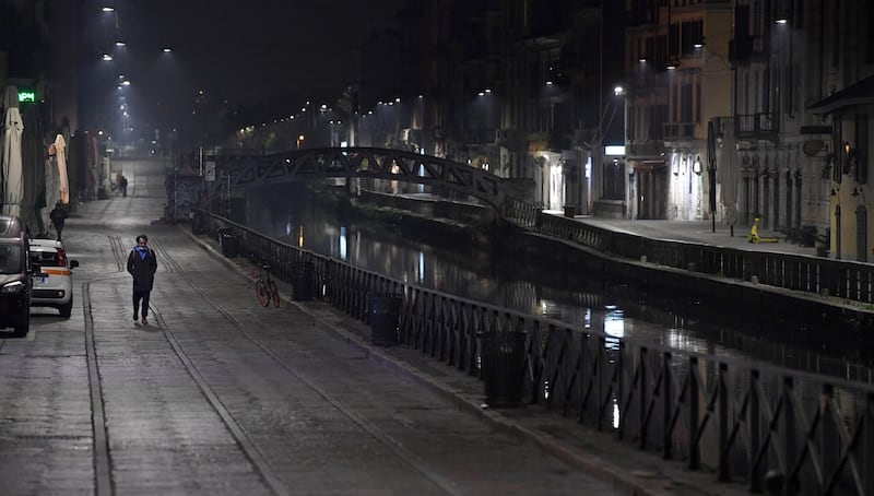 A man walks in the almost empty Navigli, the nightlife district, during the curfew in Milan, Italy. EPA