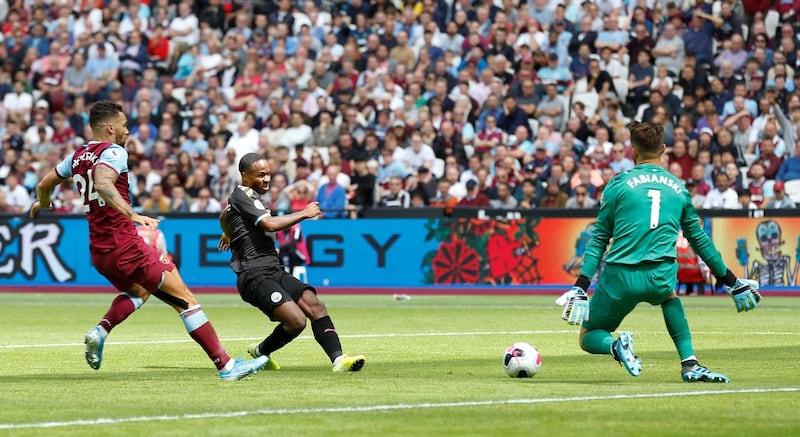 Manchester City's English midfielder Raheem Sterling (C) scores their second goal during the English Premier League football match between West Ham United and Manchester City at The London Stadium, in east London on August 10, 2019. (Photo by Ian KINGTON / AFP) / RESTRICTED TO EDITORIAL USE. No use with unauthorized audio, video, data, fixture lists, club/league logos or 'live' services. Online in-match use limited to 120 images. An additional 40 images may be used in extra time. No video emulation. Social media in-match use limited to 120 images. An additional 40 images may be used in extra time. No use in betting publications, games or single club/league/player publications. / 