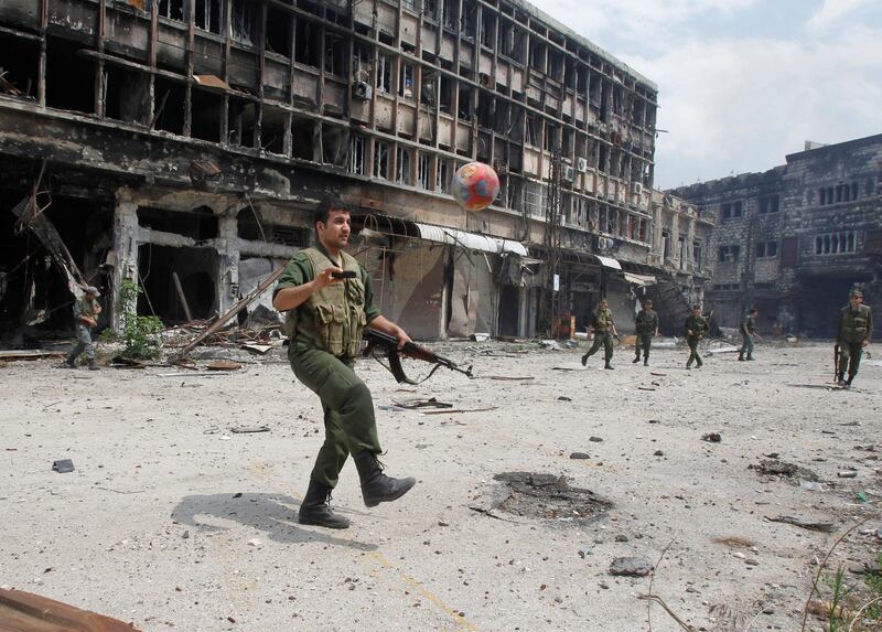 FILE PHOTO: Forces loyal to Syria's President Bashar al-Assad play football at al-Hamdeya neighborhood in Homs city, Syria May 9, 2014. REUTERS/Khaled al-Hariri/File Photo