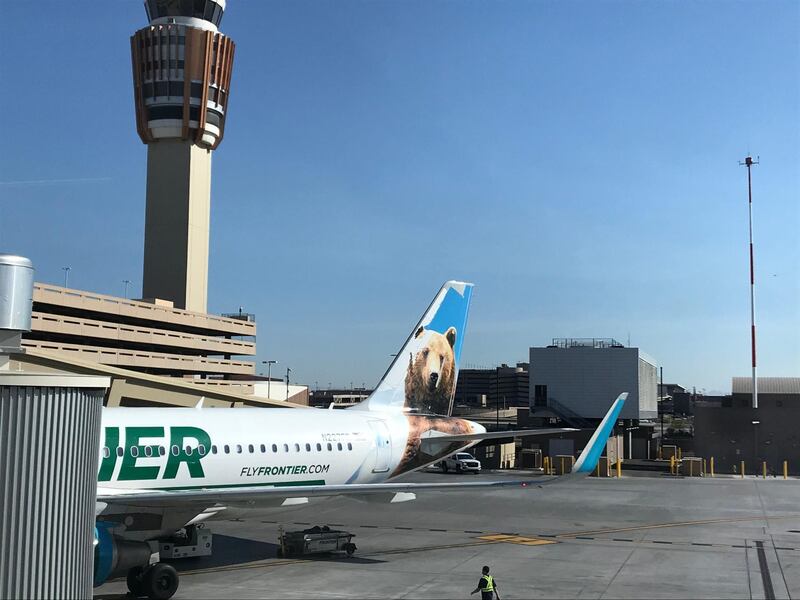 A Frontier Airline's plane waits at the gate at Sky Harbor International Airport. The ultra low cost carrier is known for its unbundled fares and airplane tales featuring different animals.Frontier air tail