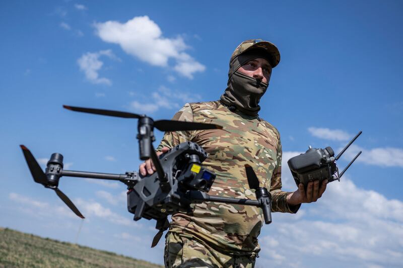 A Ukrainian serviceman carries a drone during training in Zaporizhzhia region, in August. Reuters