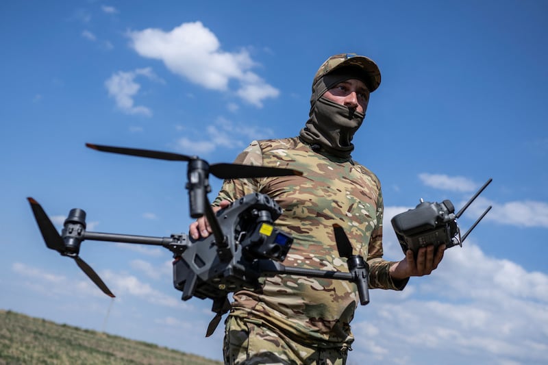 A Ukrainian soldier carries a drone and a remote control in Zaporizhzhia region. Reuters
