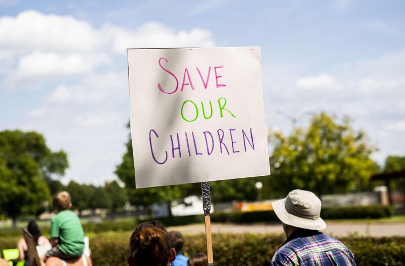 People gather during a "Save the Children" rally, inspired by the QAnon movement, outside the Capitol building on August 22, 2020 in St Paul, Minnesota. AFP