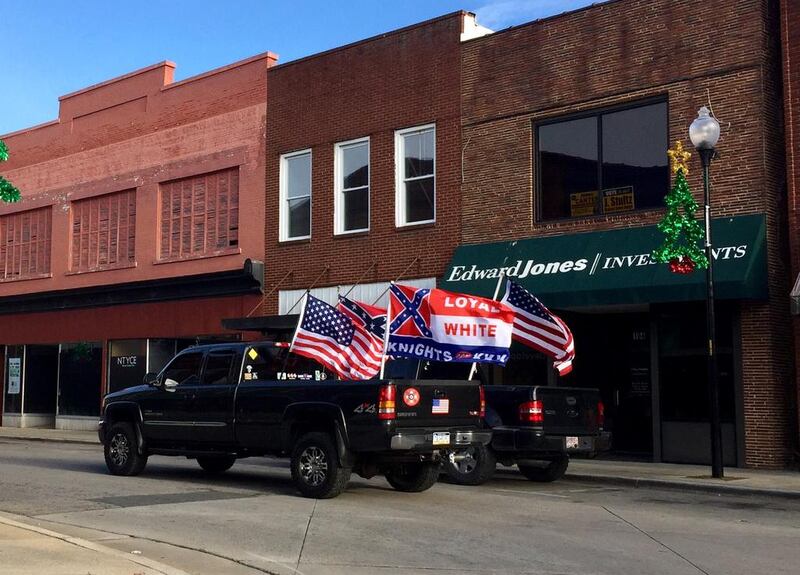 A pickup bearing the Confederate flag and emblems of the Ku Klux Klan drives up Main Street in the small North Carolina town of Roxboro. Natalie Allison Janicello for The National