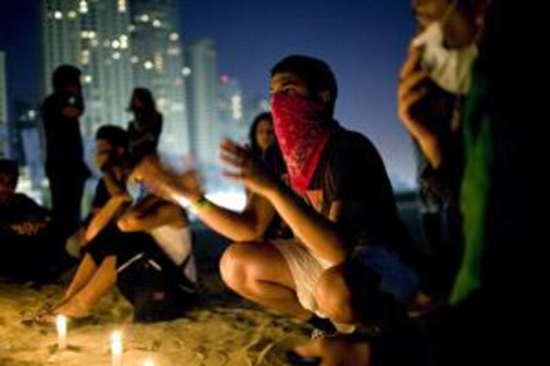 Peaceful protestors hold a candlelit vigil on the beach in front of Jumeirah Beach Residences.