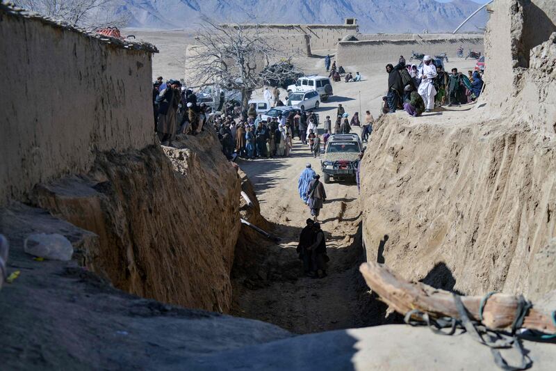 Afghan people gather as rescuers try to reach to rescue a boy, 9, trapped for two days down a well in the remote southern Afghan village of Shokak, in Zabul province, on February 17. AFP