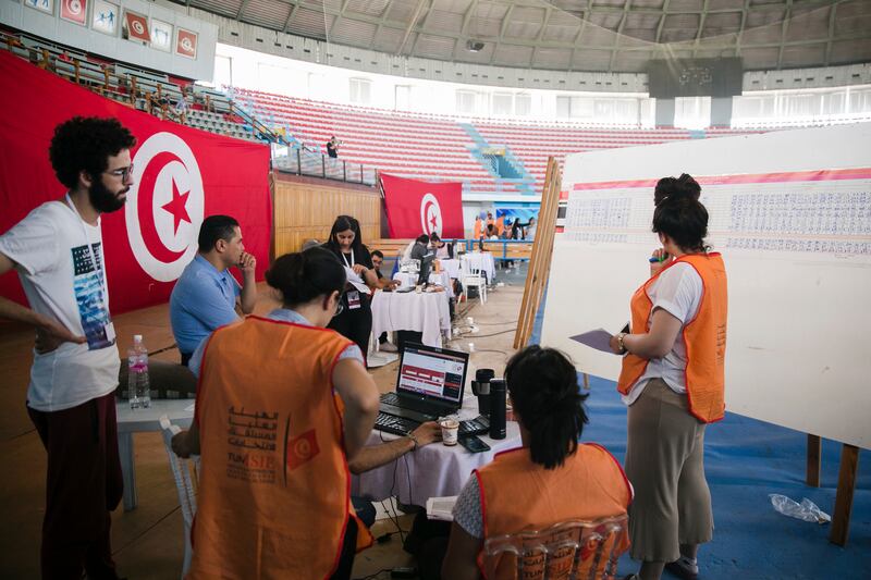 Members of Tunisia's electoral commission count the votes a day after the constitutional referendum in Tunis. AP