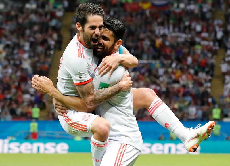 Spain's Diego Costa, right, celebrates with his teammate Isco after scoring his side's opening goal during the group B match between Iran and Spain at the 2018 soccer World Cup in the Kazan Arena in Kazan, Russia, Wednesday, June 20, 2018. (AP Photo/Frank Augstein)