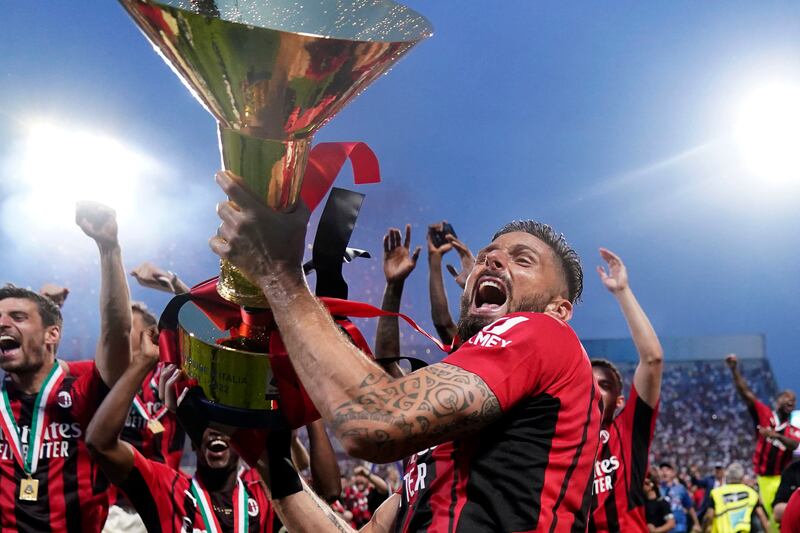 Olivier Giroud holds the Serie A trophy after AC Milan's win over Sassuolo. AP