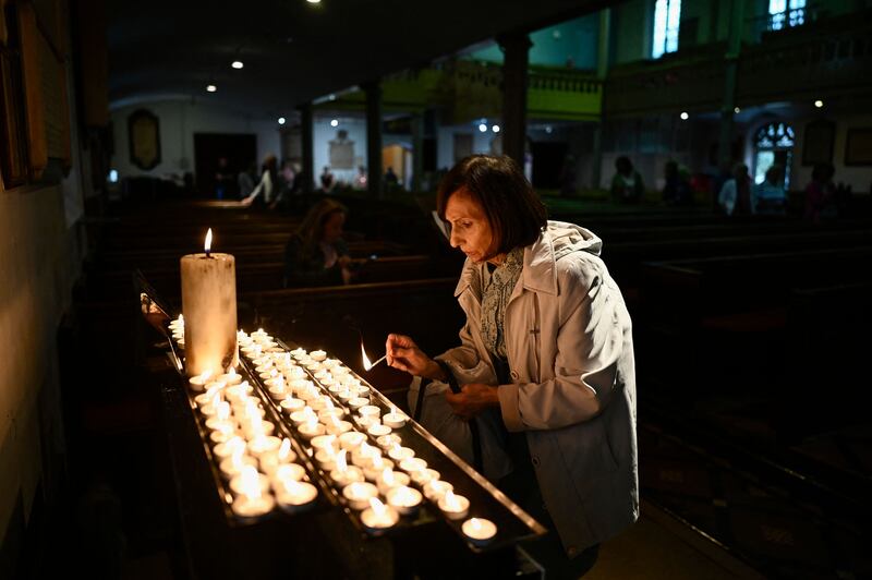 A member of the public lights a candle at Windsor Parish Church. AFP