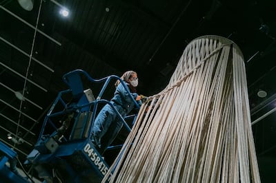 Afra Al Dhaheri installing her rope sculpture 'Tasreeha' (2020) at Manarat Al Saadiyat for Abu Dhabi Art. Al Dhaheri is one of the 2021 winners of the Misk Art Grant. Courtesy the artist