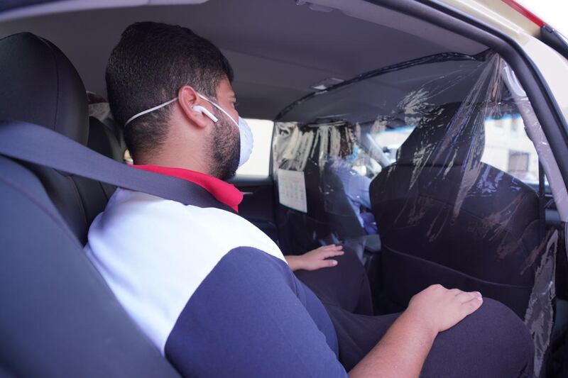 Dubai Taxi Corporation has begun installing transparent plastic protection screens in its vehicles to ensure a full separation between drivers and passengers. Courtesy - Dubai Government Media Office