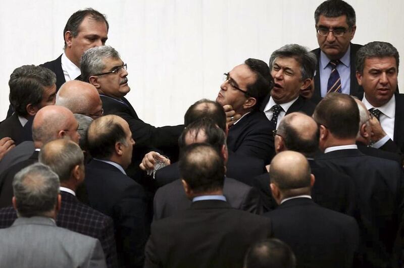 Turkish legislators from prime minister Recep Tayyip Erdogan's ruling party and the main opposition party brawl during a tense all-night debate over a controversial law on changes to a council that appoints and overseas judges and prosecutors, in Ankara on February 15, 2014. One legislator suffered a broken finger while another suffered a nose-bleed. Opposition parties say the bill would give the government wider controls over the council. AP