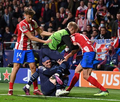 Oleksandr Zinchenko of Manchester City holds off Stefan Savic of Atletico Madrid with Phil Foden on the ground. Getty