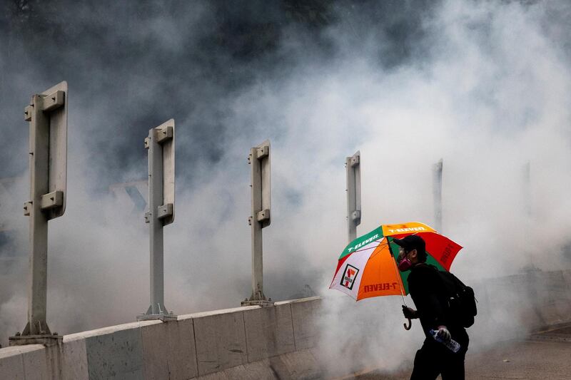 An anti-government protester runs away from tear gas during a demonstration in Wan Chai district in Hong Kong, China. Reuters