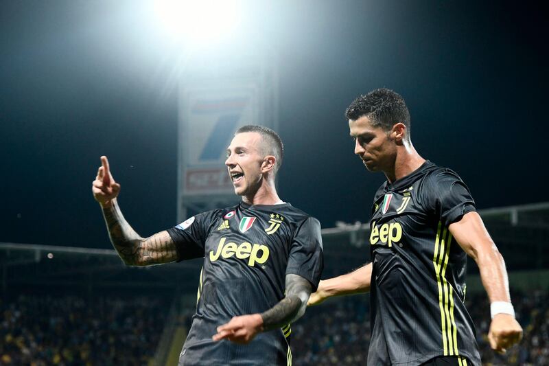 Federico Bernardeschi celebrates with Cristiano Ronaldo after scoring Juventus's second goal. AFP