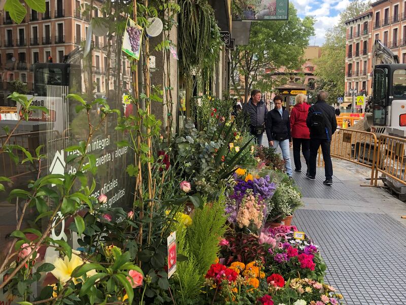 Shoppers outside a flower market in Madrid. Holly Aguirre / The National