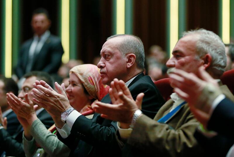 In this Wednesday, March 6, 2019, photo Turkey's President Recep Tayyip Erdogan, center, attends an event in Ankara, Turkey. In an interview on Wednesday, Erdogan dismissed U.S. threats to cancel the sale of high-tech F-35 jets to Turkey, saying his country will move ahead with the purchase of Russian S-400 air-defense missiles. (Presidential Press Service/Pool Photo via AP)